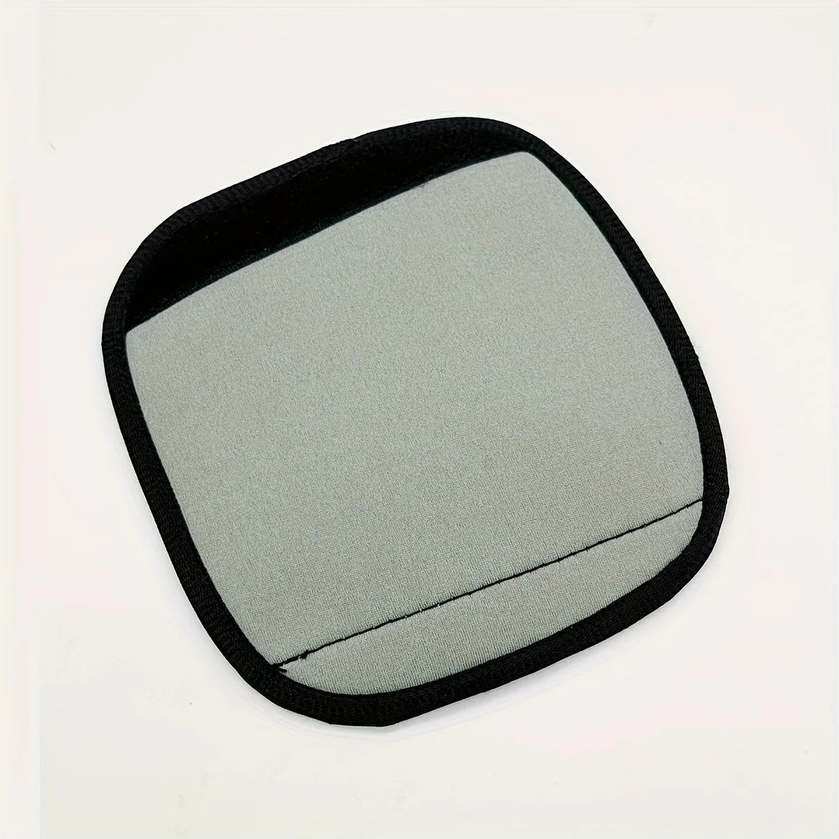A square neoprene luggage handle cover with a cushioned grip in a light gray color.