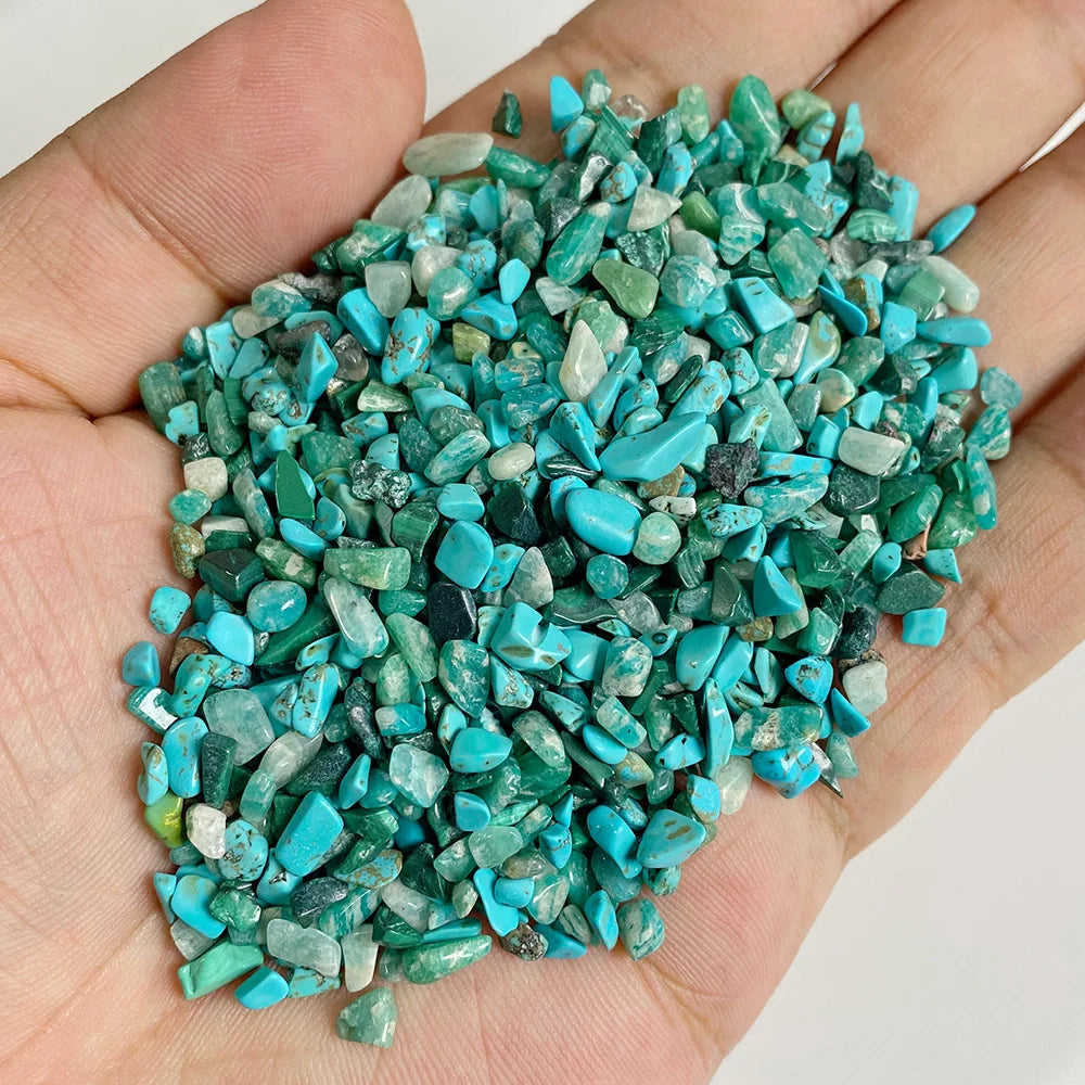 A handful of bright turquoise and green natural tumbled stone chips for jewelry making