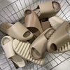 A collection of beige EVA platform slides for beach and home use displayed in a wire basket.