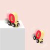 A magnetic wooden number train set shaped like the number zero, featuring red and yellow components.