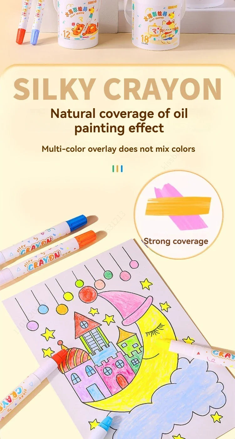 A set of silky crayon sticks in various colors is shown next to a drawing on paper demonstrating strong coverage.