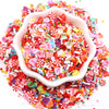 A pile of colorful polymer clay sprinkles mix in various shapes and colors for slime decor and DIY crafts.