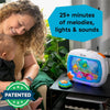 An ocean-themed crib soother with remote, lights, and melodies is shown next to a baby.