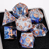 A collection of handmade resin sharp edge dice in various colors and shapes displayed on a dark surface.