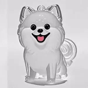 A clear, dog-shaped pet hair keepsake keychain with large eyes and a smiling expression.