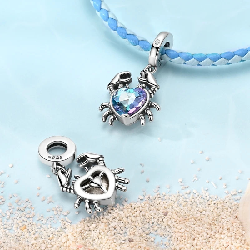 Sterling silver ocean life charm pendant set featuring starfish, sea turtle, and whale shark charms on a blue beaded necklace