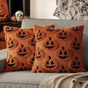 A set of orange Halloween pillow covers featuring black carved pumpkin designs on a textured fabric.