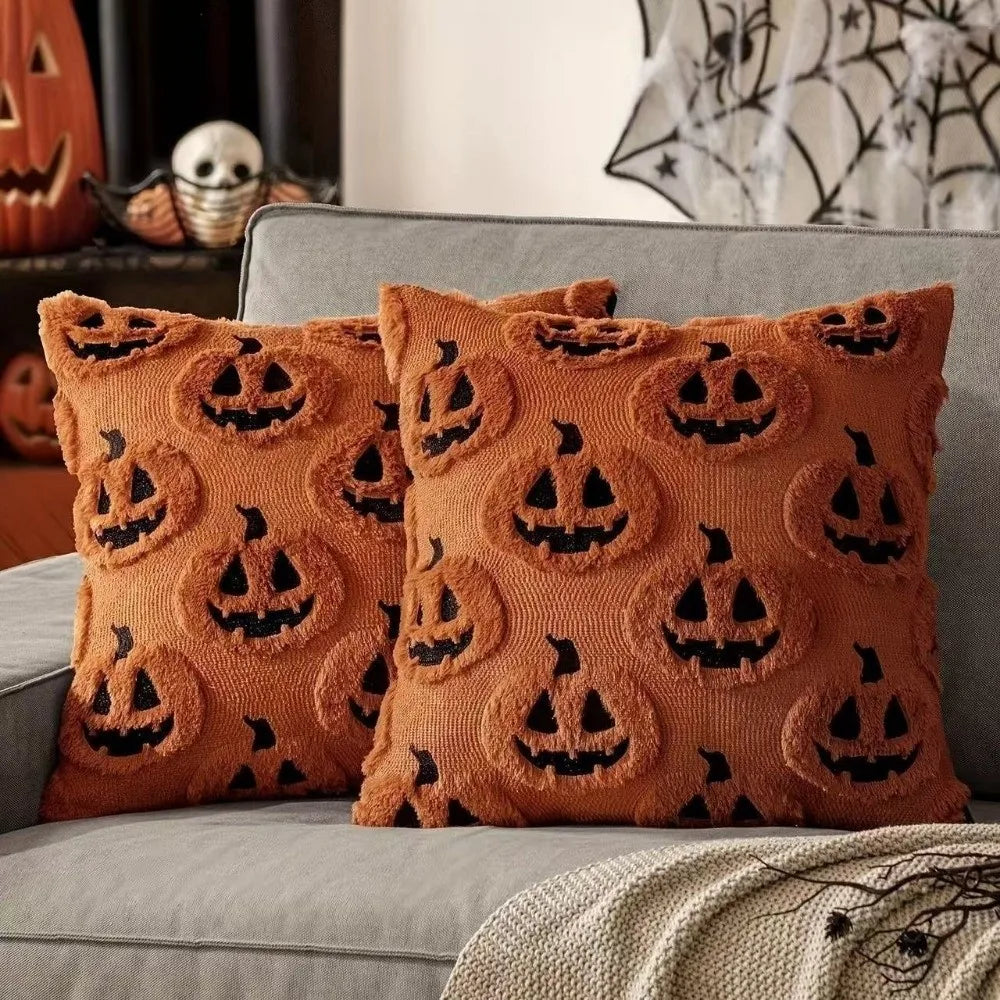 A set of orange Halloween pillow covers featuring black carved pumpkin designs on a textured fabric.