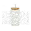 A clear glass jar with a lid and a straw, filled with leopard print UV DTF cup wraps.
