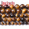 A collection of polished, natural yellow tiger eye stone beads used for jewelry making.