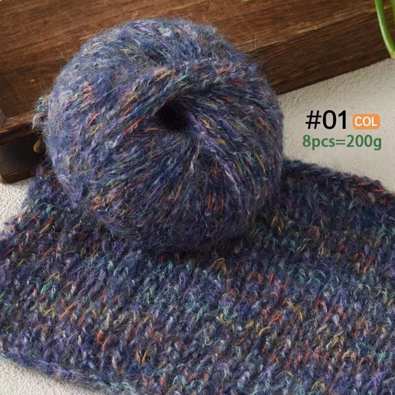 A ball of dark blue purple alpaca blend yarn with multicolored fibers resting on a light surface.