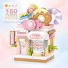 A building block set depicting a sweet candy shop storefront with pink and white elements and various candy-themed items.