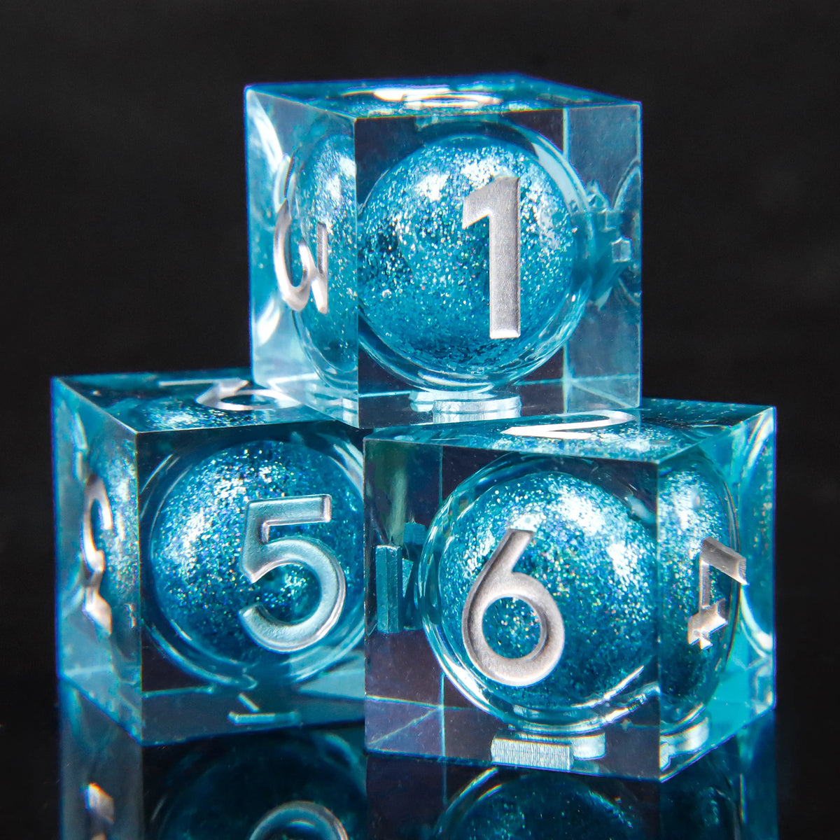 A set of blue resin dice showing the number one and six, inspired by Lord of the Rings.