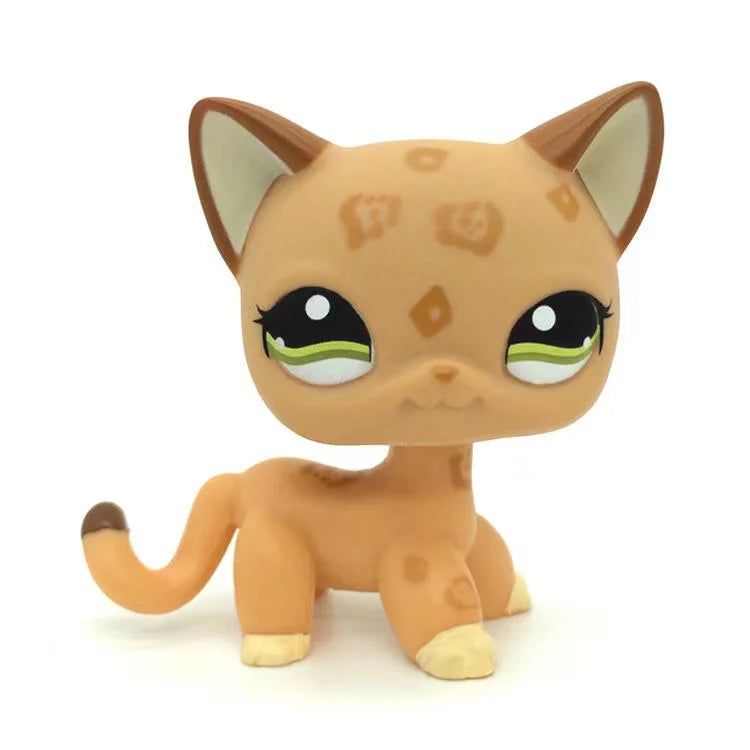 A small, orange and tan Littlest Pet Shop style standing dog figure with large eyes.