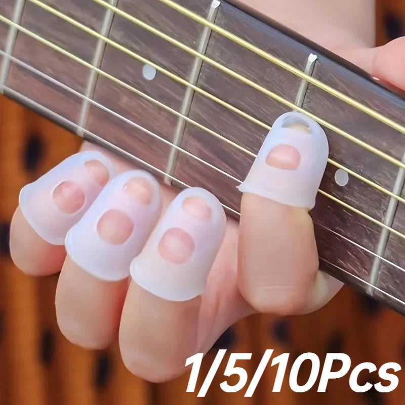 A hand is holding silicone guitar finger sleeves on fingers, demonstrating the product for practice and protection.