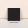 A black square jewelry display card with two circular openings is shown against a light background.