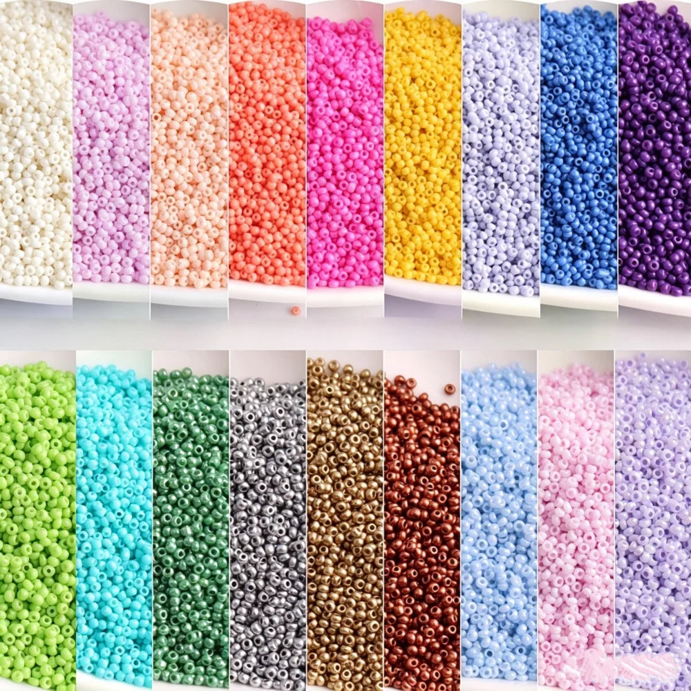 A colorful assortment of 1.5mm solid glass seed beads in various shades including pink, purple, yellow, blue, and green.