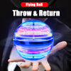 A blue, spherical LED flying ball is being held and rotated by a hand against a dark background.