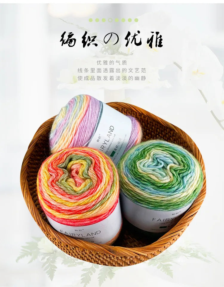 A bundle of gradient rainbow cotton-wool yarn in various colors is displayed in a woven basket.