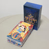 A blue box of the Rider-Waite Tarot Deck is shown next to a stack of tarot cards on a light surface.