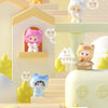 A display of various cat mini figurines in cute packaging and on a tiered shelf.