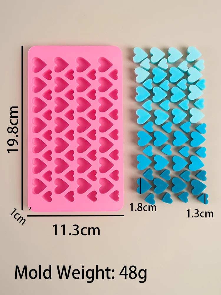 A pink silicone mold set with heart shapes is shown next to the flat mold and individual hearts.