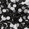 A close-up view of small, round black and silver glass crystal flatback rhinestones.