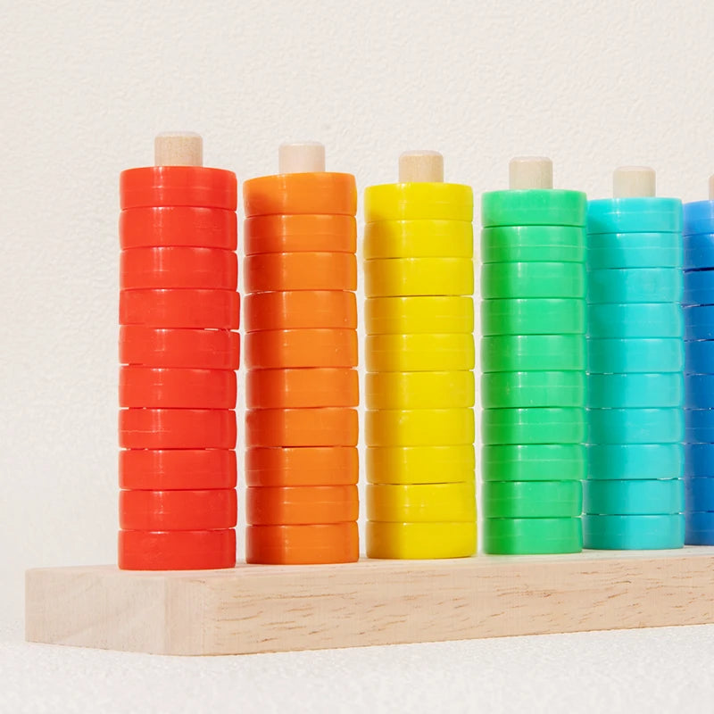 A wooden ring toss game with colorful stacking rings in shades of orange, yellow, and green.
