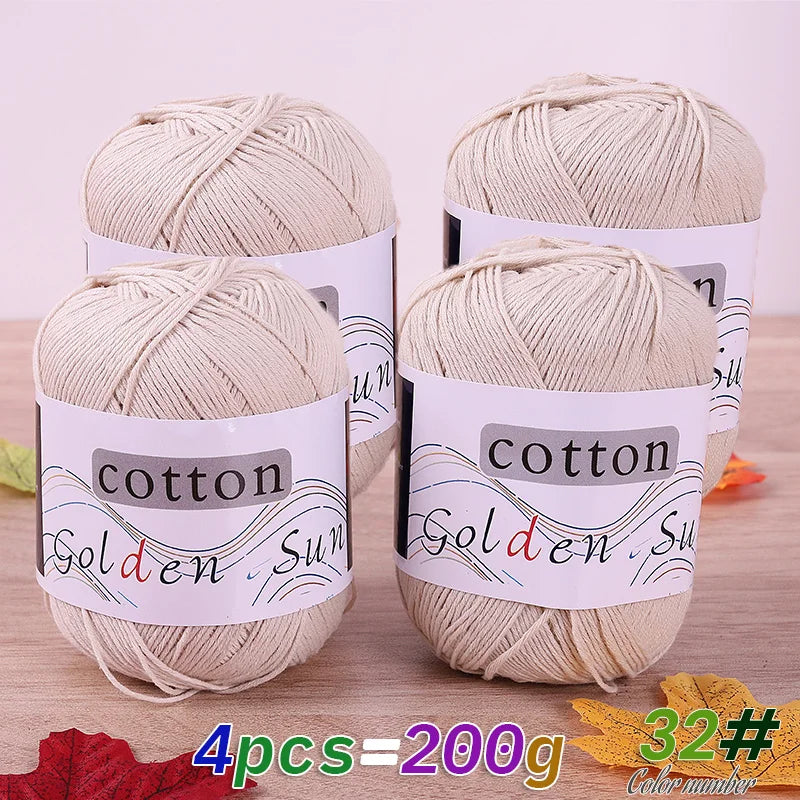 Four skeins of natural beige cotton knitting yarn for crochet and handmade projects