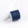 A roll of dark blue 0.8mm cotton nylon macrame cord for jewelry making and crafts.