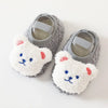 Pair of soft gray and white cartoon bear baby booties for infants