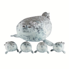 A plush seal family pillow featuring one large adult seal and four smaller baby seals.