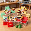 A collection of miniature food items and accessories displayed in various colored boxes and on a wooden table.
