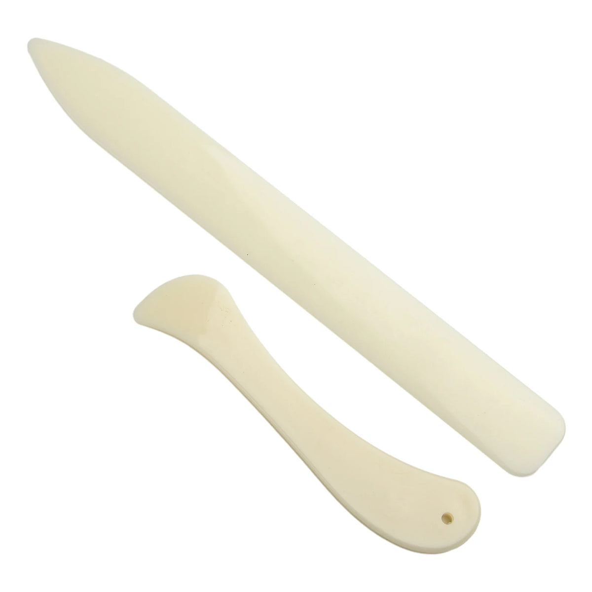 A white plastic bone folder used for paper creasing and folding crafts.