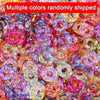 A close-up of multiple colors of wave-patterned acrylic beads randomly shipped for jewelry making
