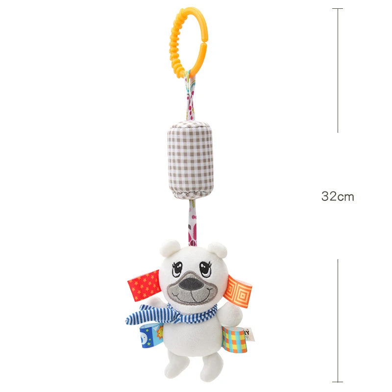 A white bear plush toy with a yellow ring hanger and colorful fabric accents.