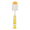 A white baby bottle cleaning brush with an orange bristled head and a yellow suction stand.