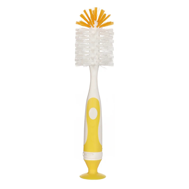 A white baby bottle cleaning brush with an orange bristled head and a yellow suction stand.