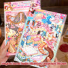 A hand holds a sheet of magical secret realm miniature landscape stickers featuring colorful fantasy scenes and architecture.
