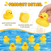 A yellow silicone squeaky duck toy floating in blue water.