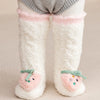 Pair of white fuzzy baby knee-high socks with pink trim and fruit-shaped appliqués