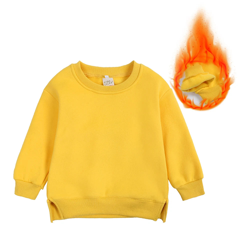 A yellow kids pullover hoodie with a hood and sleeves is shown, emitting an orange flame effect.