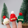A set of mini rubber duck accessories including a hat, sunglasses, and other items displayed on fingers.