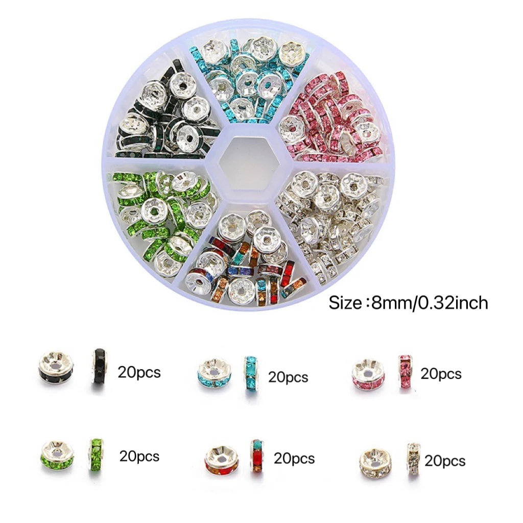 A circular tray of various colored crystal rondelle spacer beads for jewelry making, including clear, green, blue, and red st