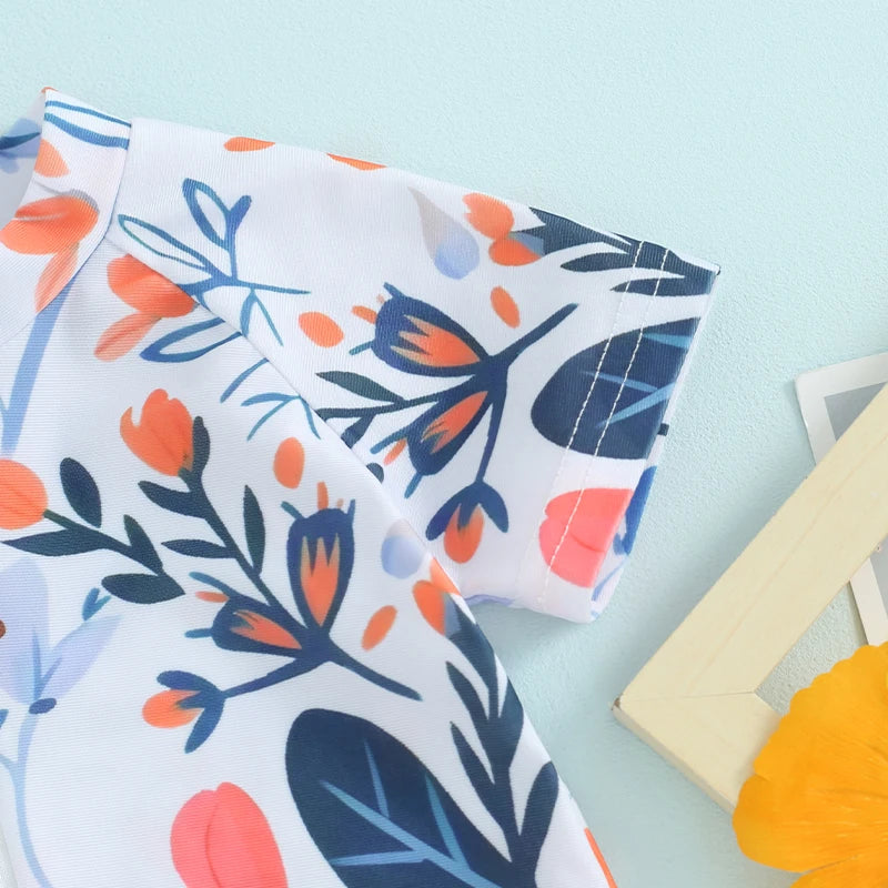 White baby rash guard swimsuit with blue and orange floral print shown in a close-up view.