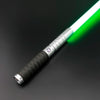 A premium metal lightsaber with an illuminated green blade and a black grip is shown diagonally against a dark background.