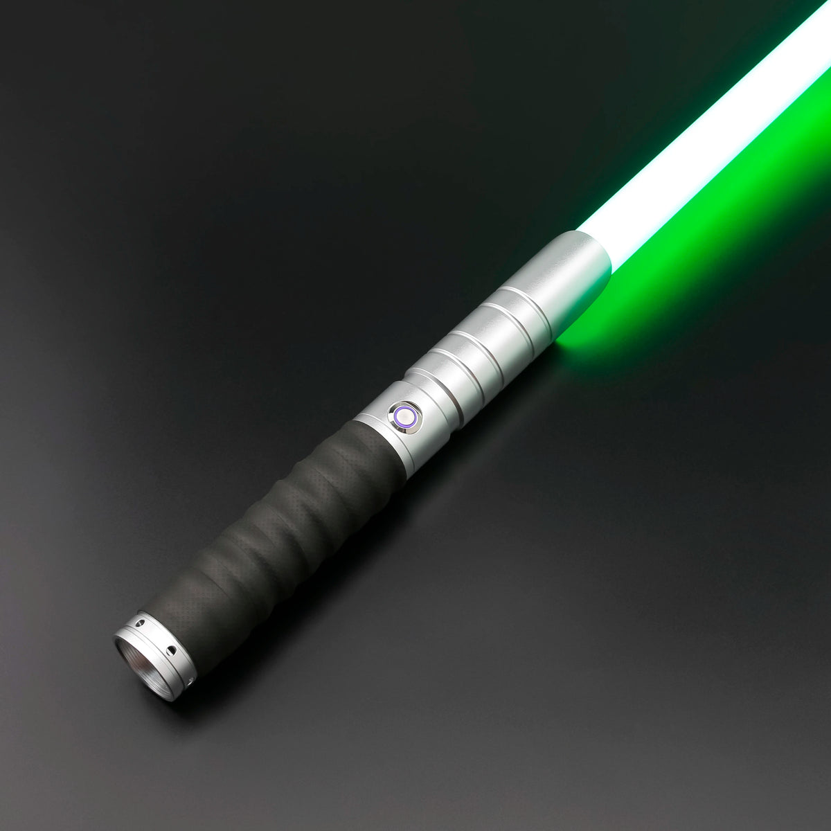 A premium metal lightsaber with an illuminated green blade and a black grip is shown diagonally against a dark background.