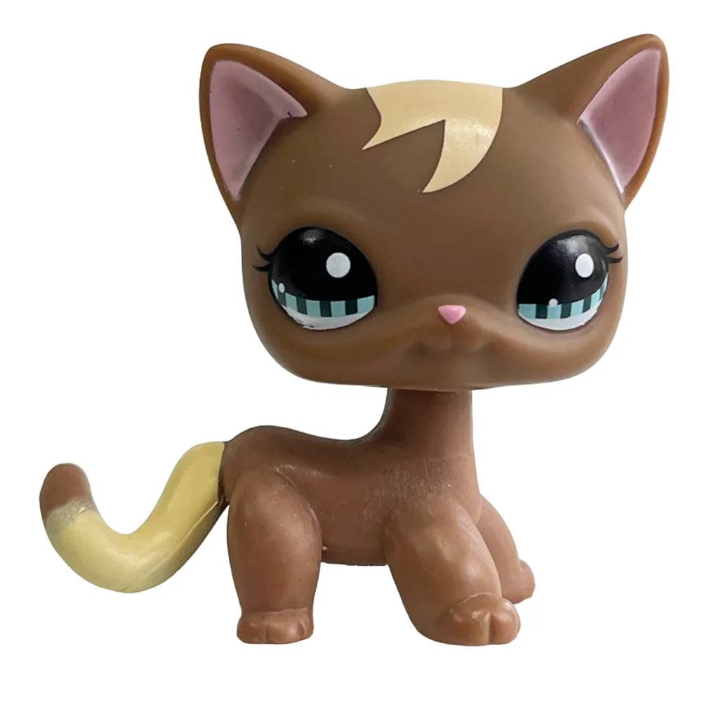 A brown cat bobble head figurine with large green eyes and light tan ears.