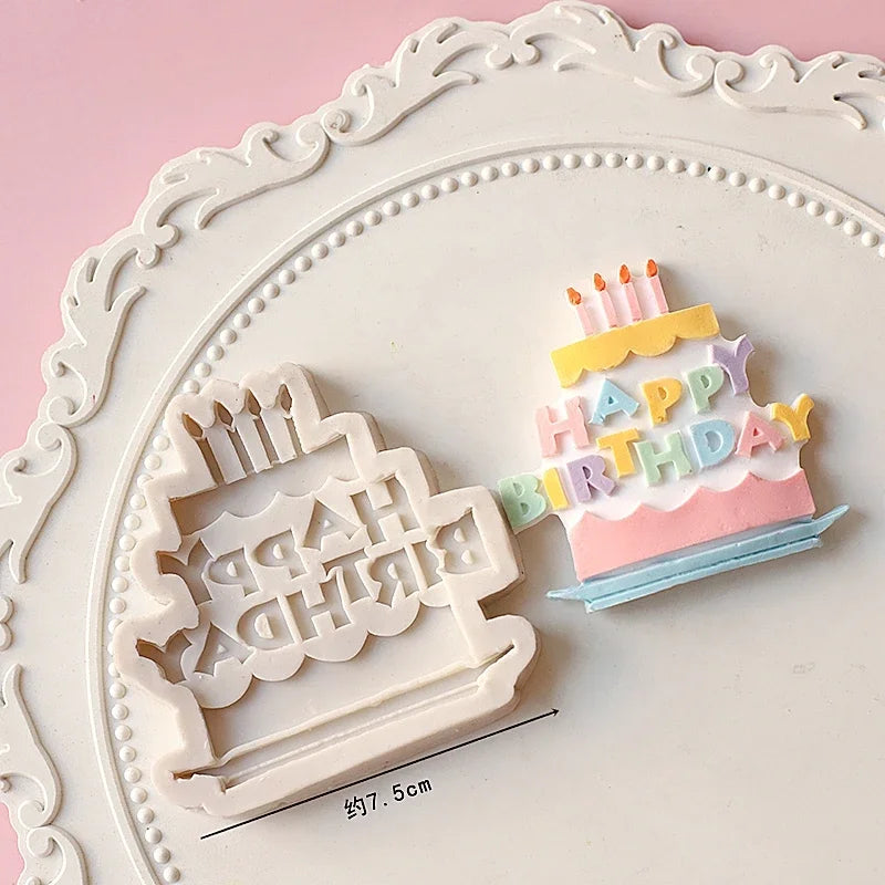White silicone cake molds featuring a birthday candle design and text on a pink background.