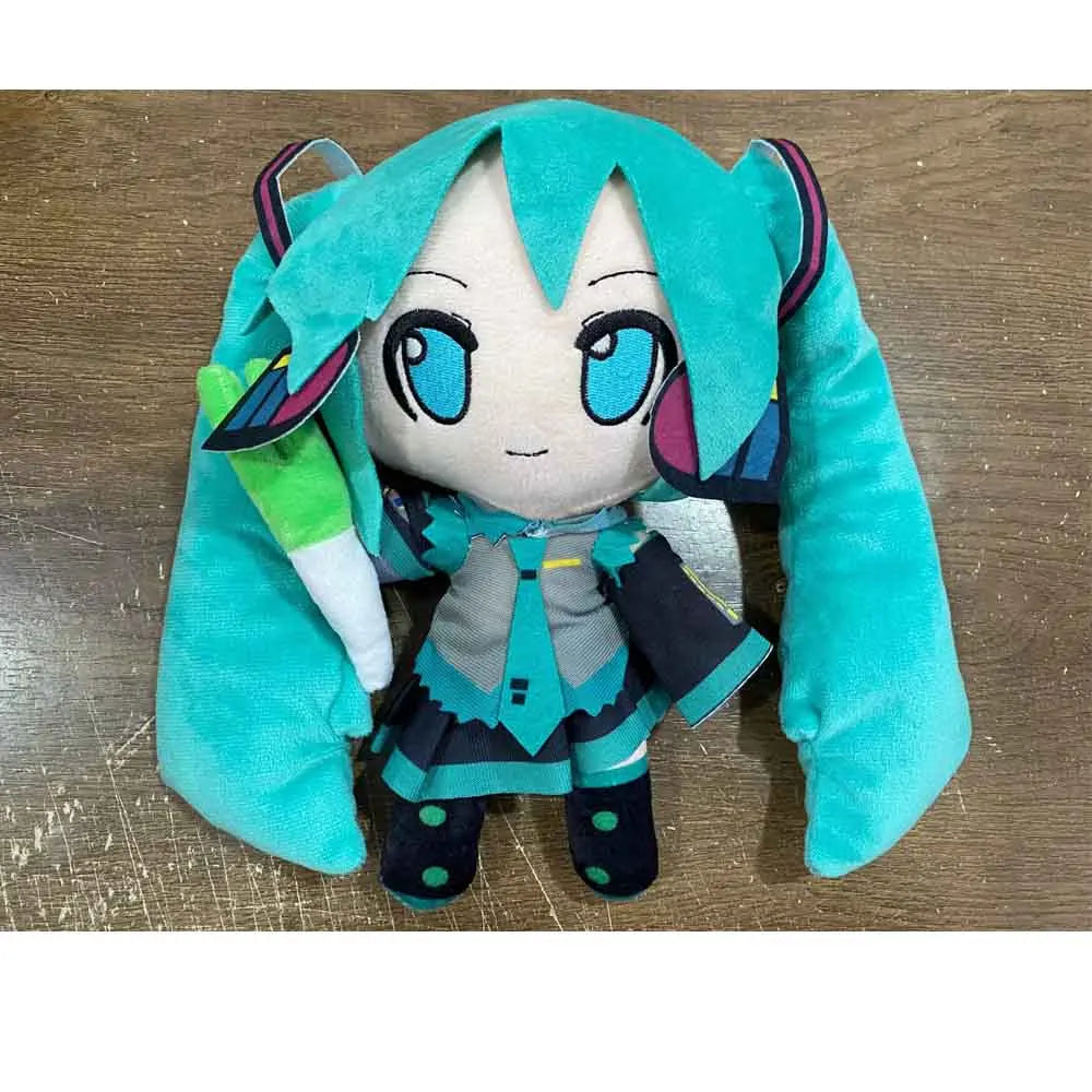 A cute teal plush doll of Hatsune Miku with large blue eyes and green hair.